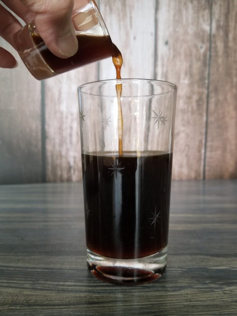 pouring espresso in americano